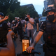 Jacob Wohl shouts over a megaphone and taunts anti-Trump protestors in Washington D.C. during a 2020 rally.